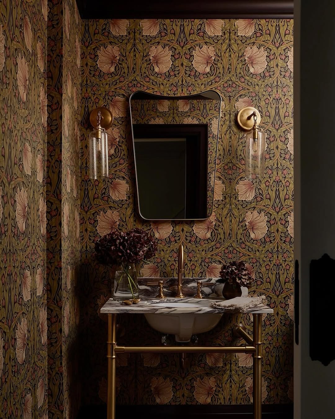 Floral Wallpaper and Gold Sconces Create Ambiance