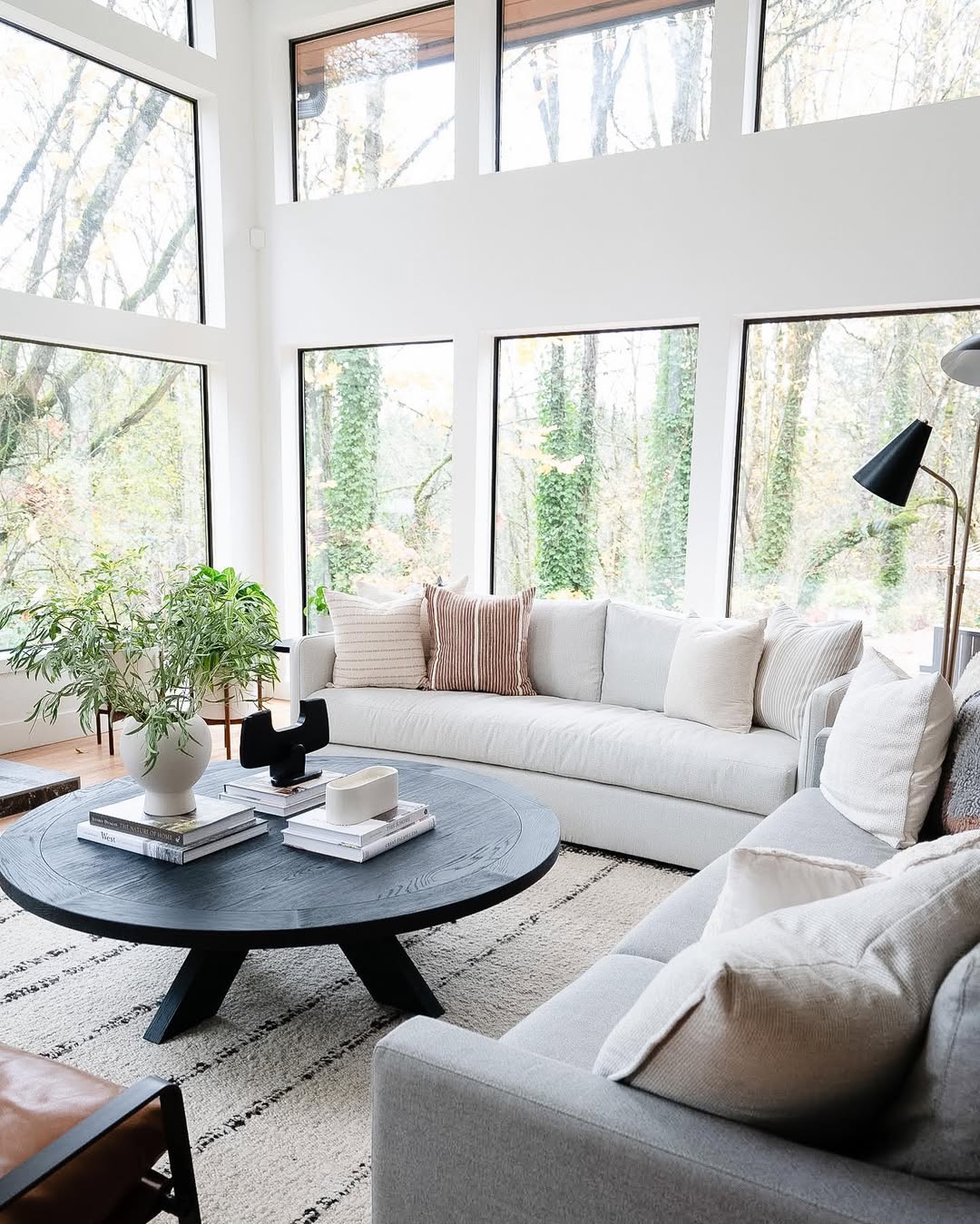 Layered Books and Artful Objects on a Round Coffee Table