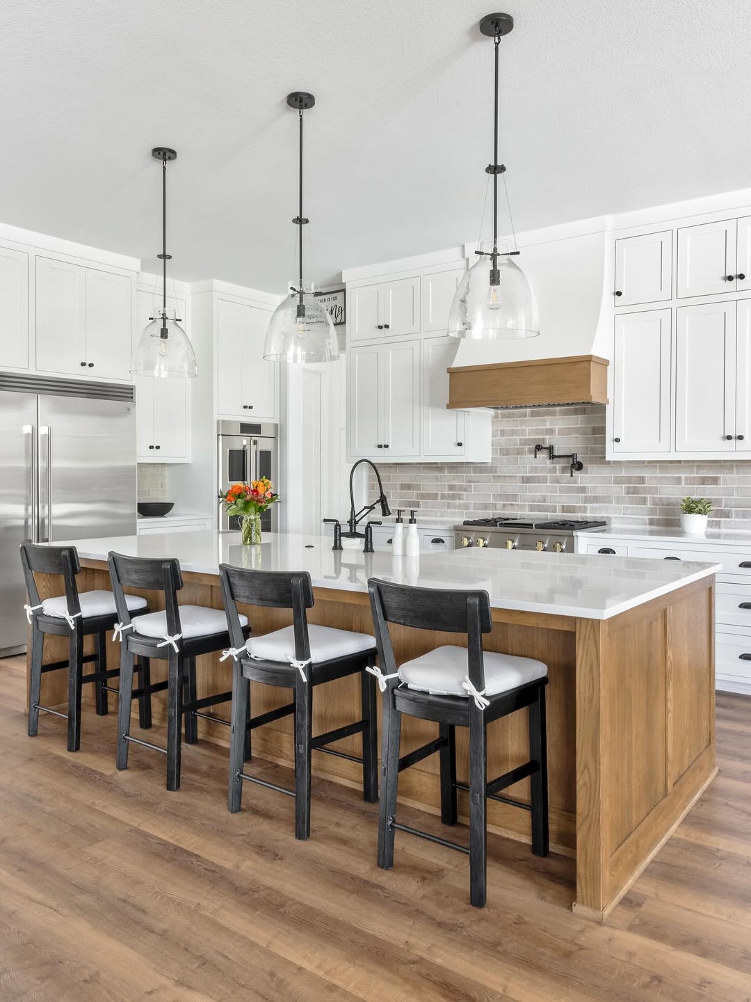 Clear Bell Pendant Lights Add Airy Touches Above Island