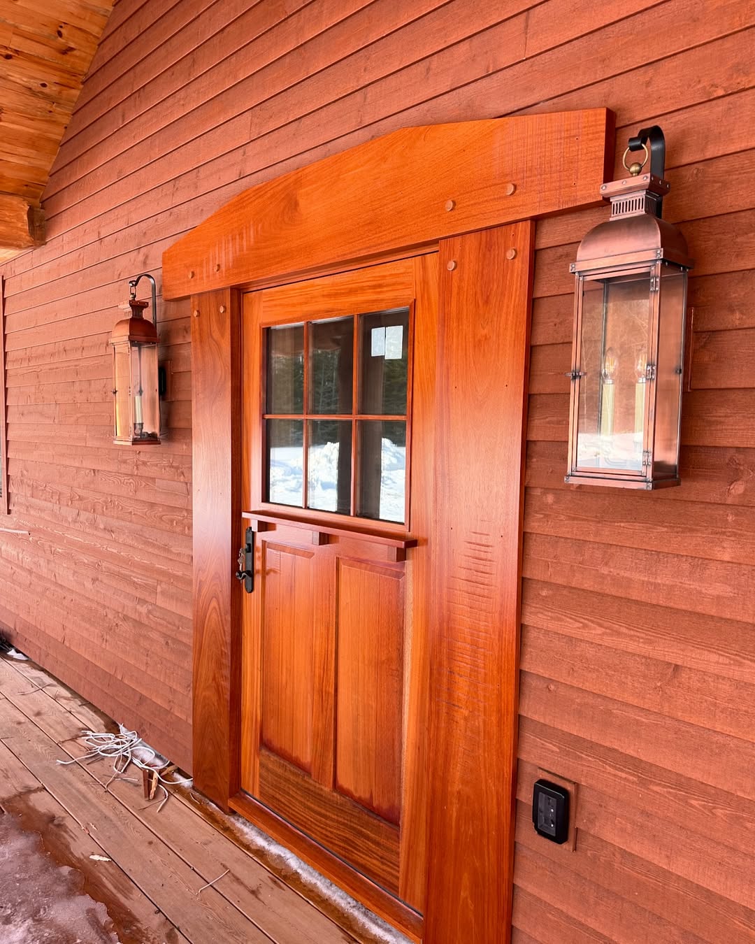 Copper Lanterns Add Warm Ambiance Beside a Wooden Door