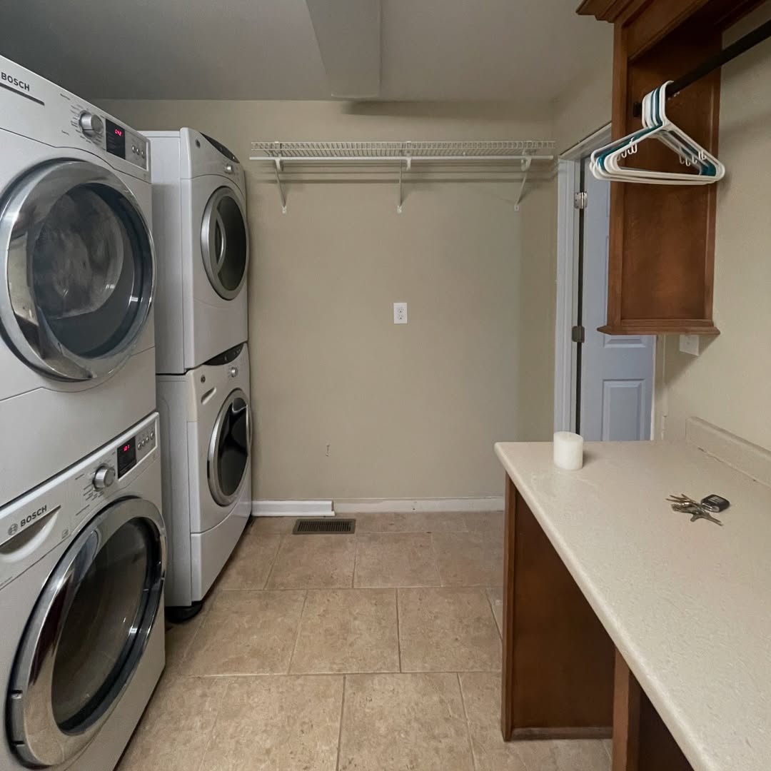 Wall-Mounted Shelf Above Stacked Washer and Dryer