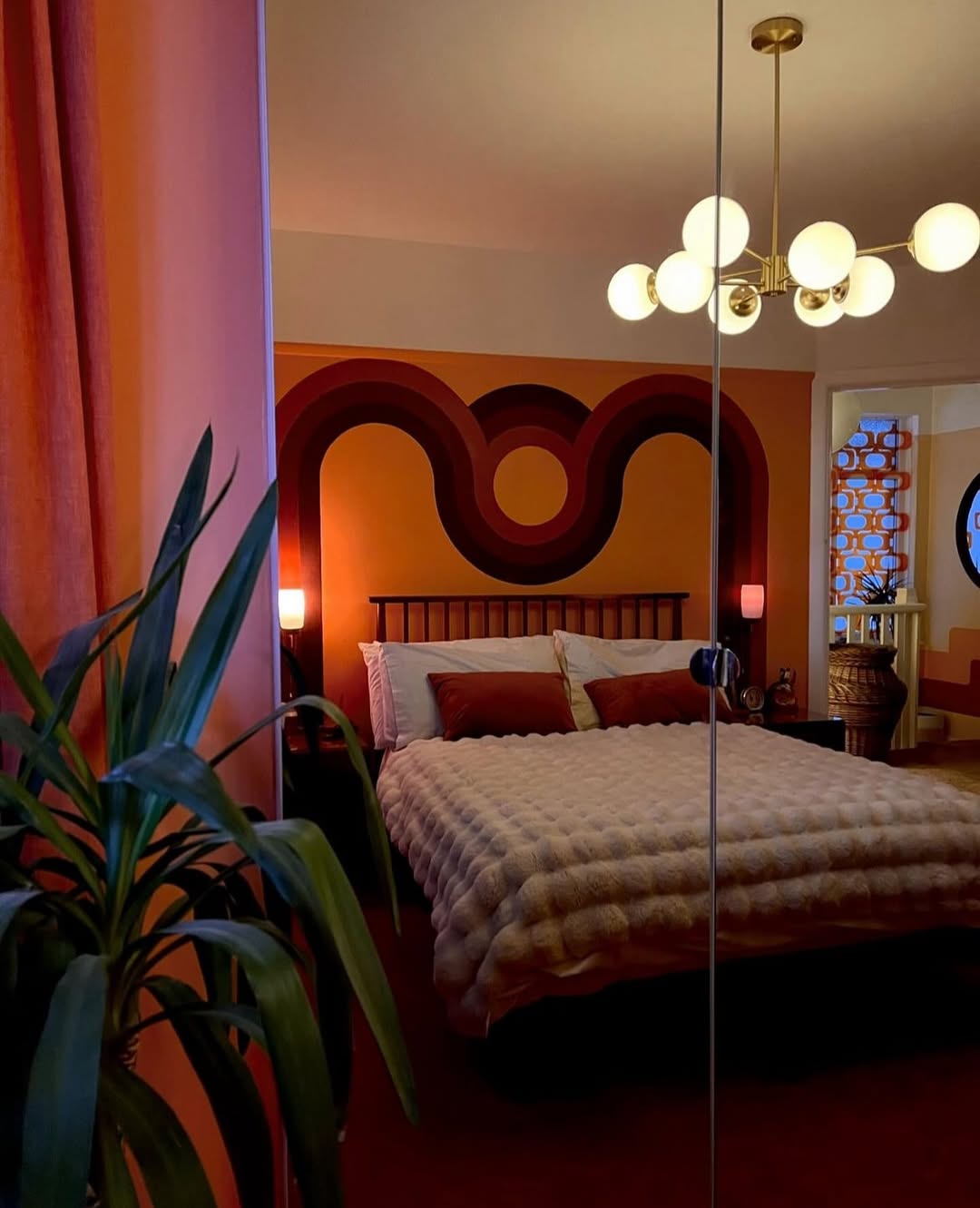 Retro Mural Adds Bold Geometric Backdrop Behind the Bed