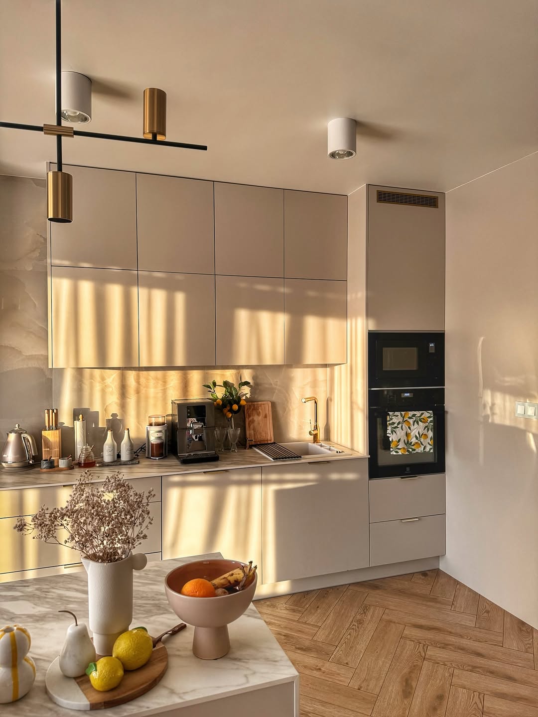 Pair Sleek Beige Cabinets with a Gold Faucet