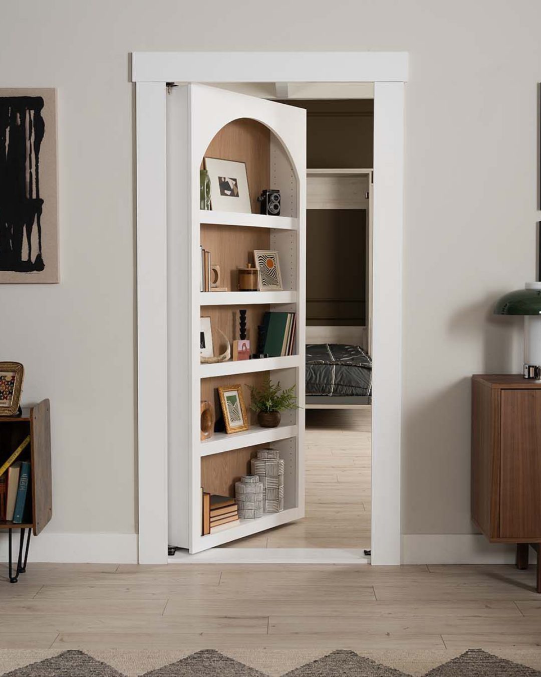 Arched White Bookshelf Door Conceals a Bedroom