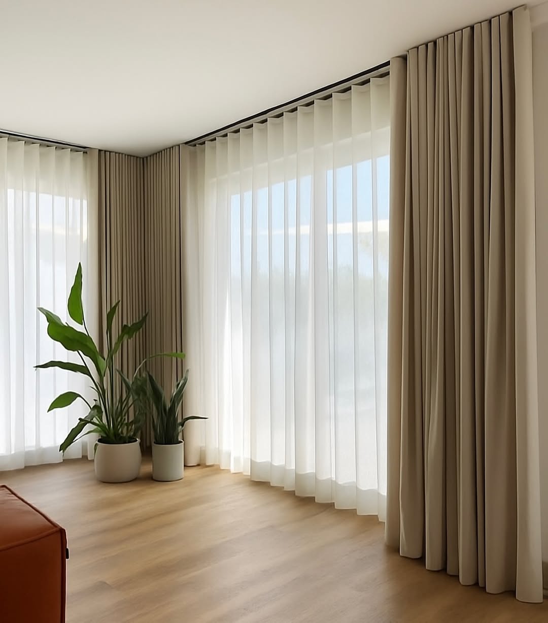 Layered S-Fold Curtains Create a Softened Window Wall