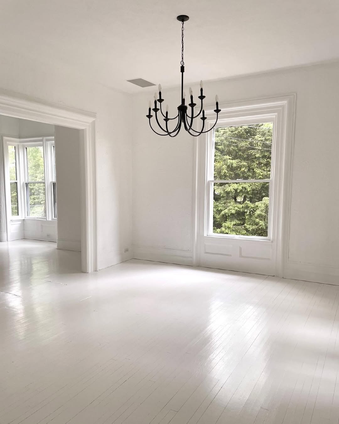 Black Chandelier Adds Dramatic Contrast to White Room
