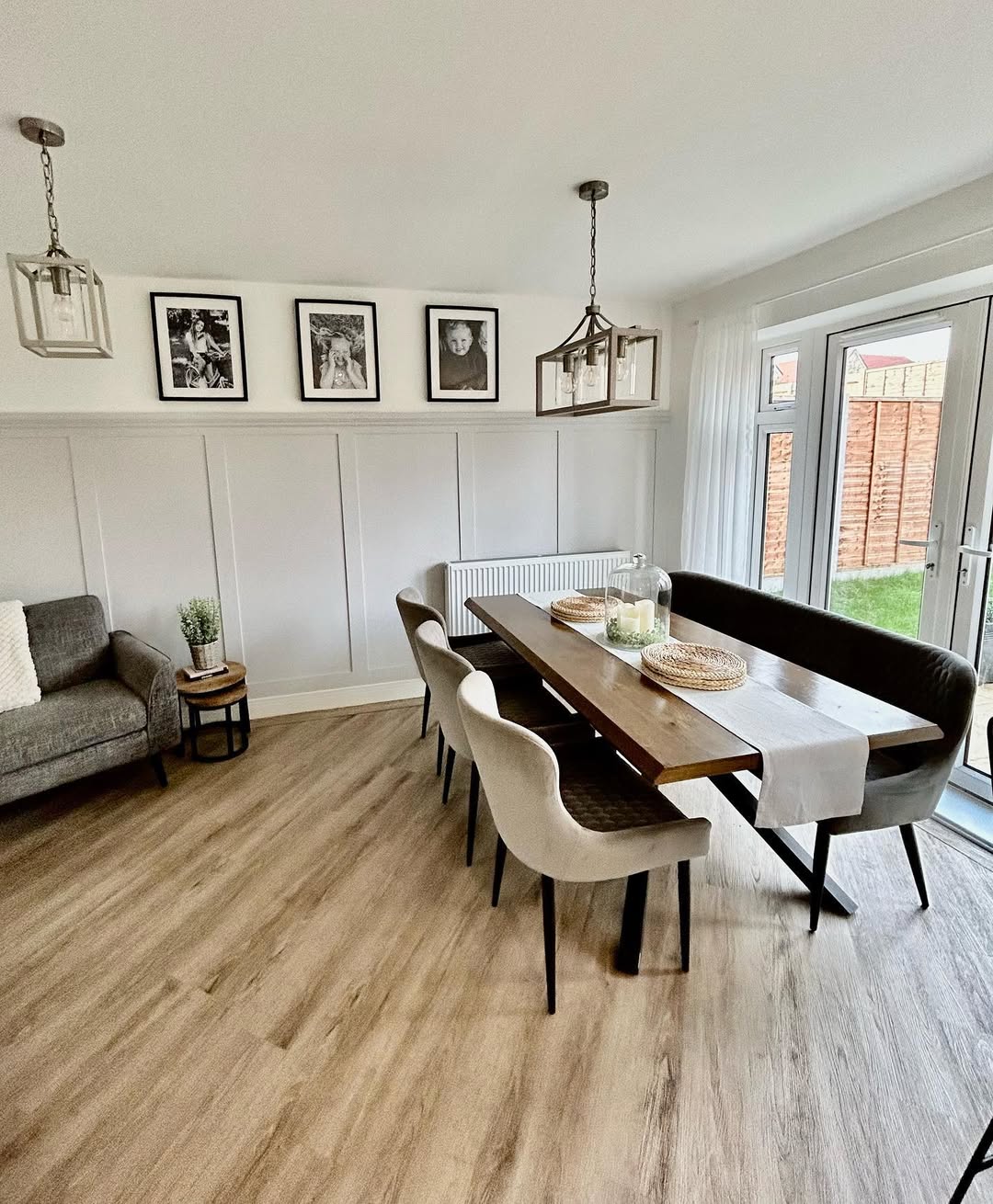 Framed Black and White Photos Add Personal Touch Above Wainscoting