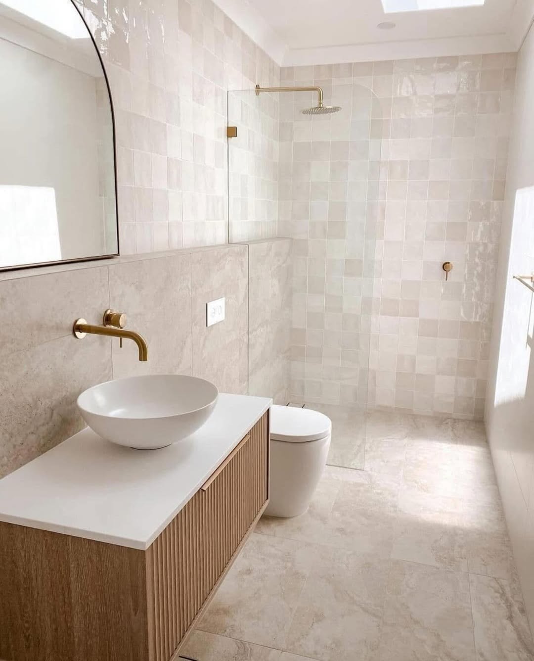 Fluted Wood Vanity Adds Warm Texture To A Neutral Bathroom