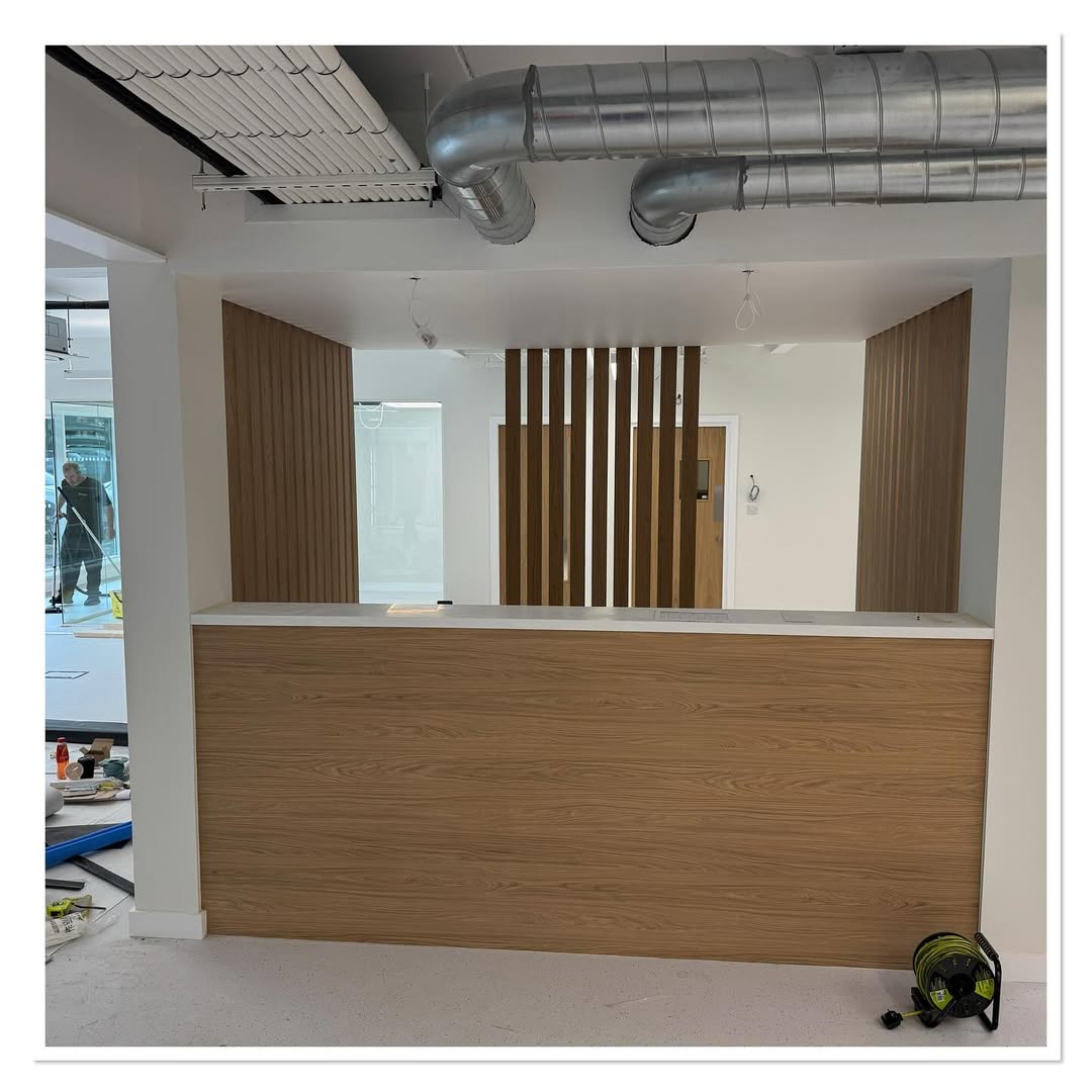 Wood Slat Divider Adds Warmth Behind a Modern Desk