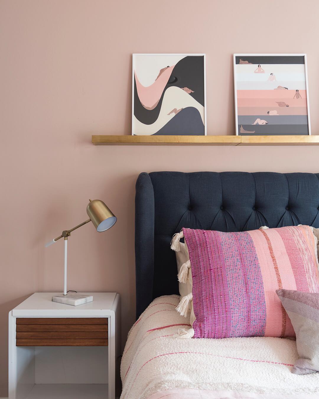 Gold Shelf Adds Warmth Above Tufted Headboard