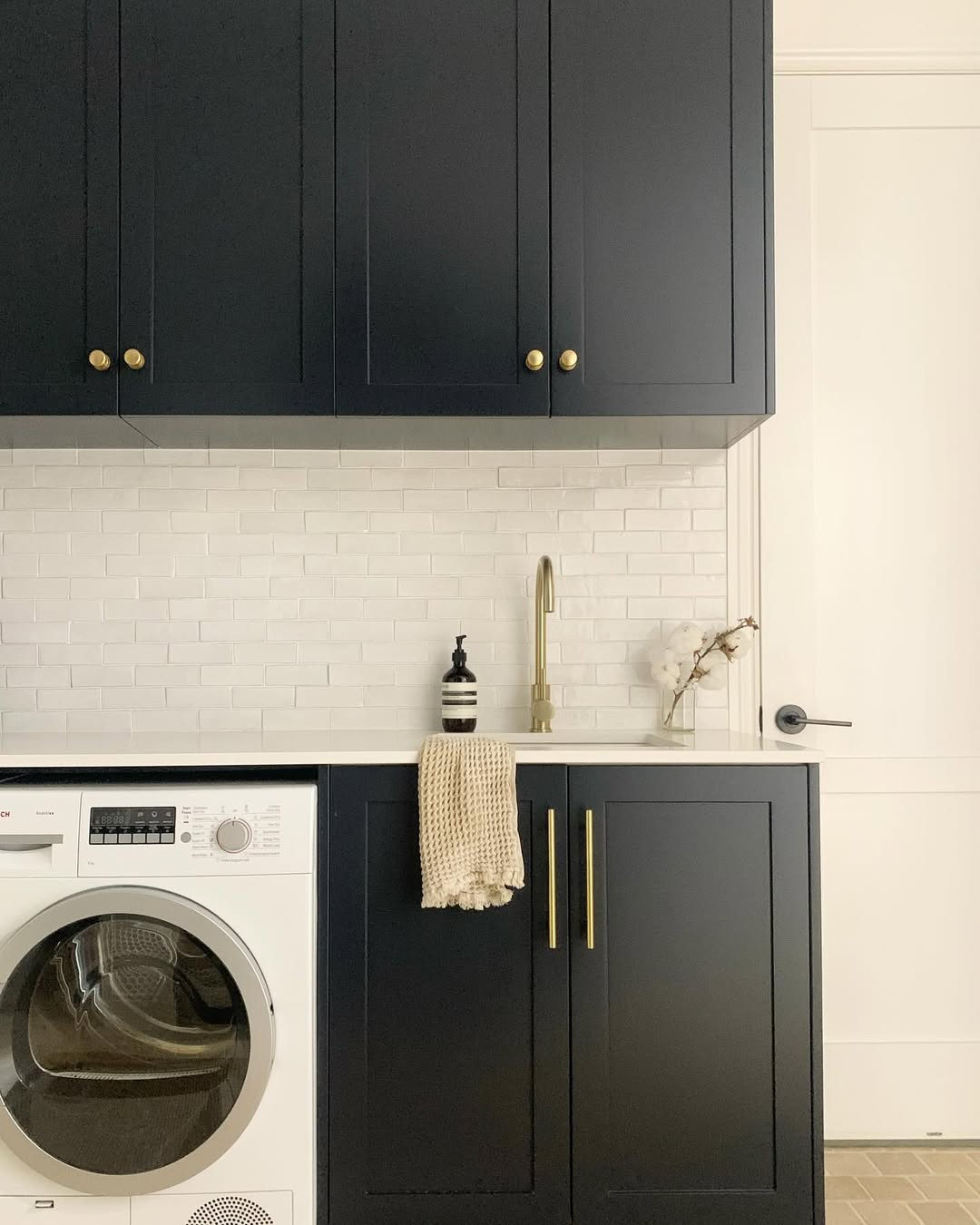 Dark Blue Cabinets With Brass Hardware Add Sophistication