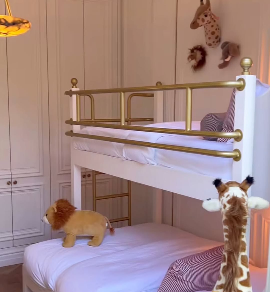 White Bunk Bed with Gold Railings and Animal Wall Decor