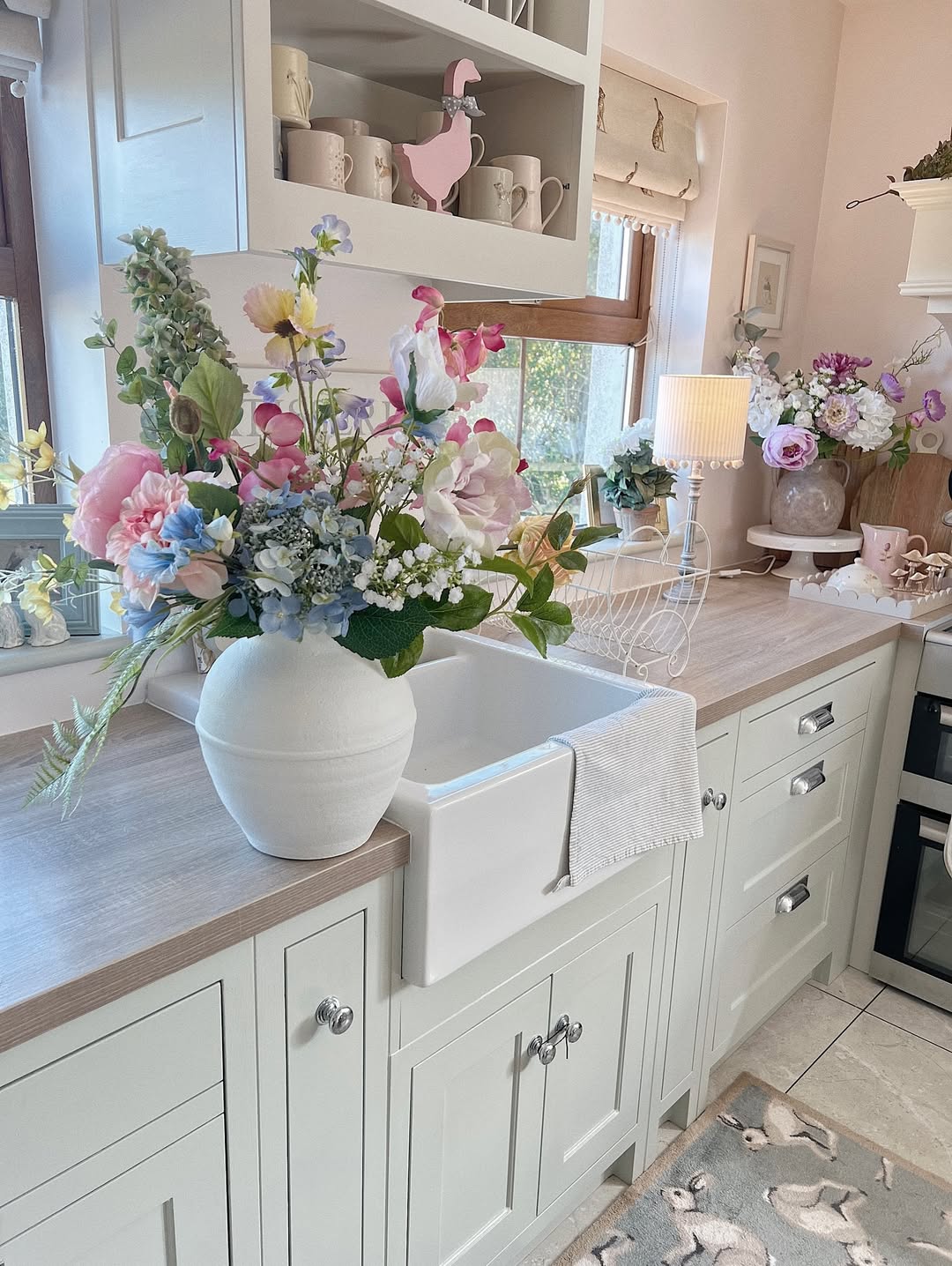 Round White Vase Anchors A Generous Floral Arrangement