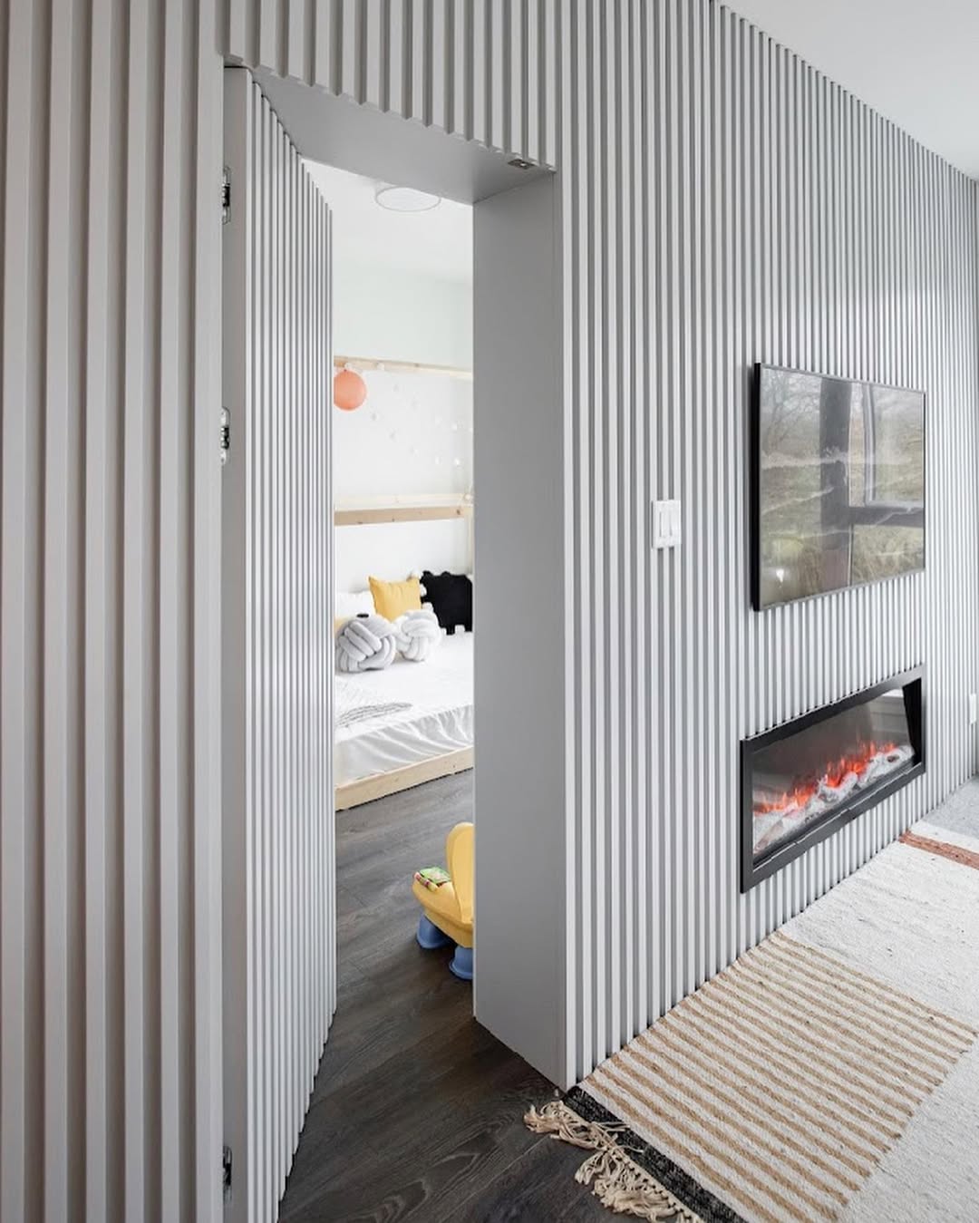Grooved Wall Panels Conceal a Sliding Doorway