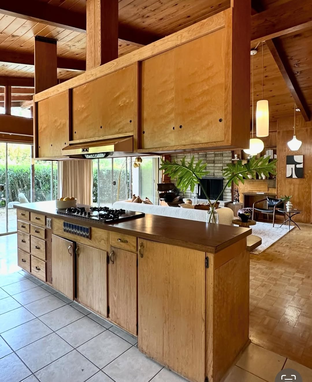 Wood Cabinetry with Sliding Doors Hides Kitchen Clutter