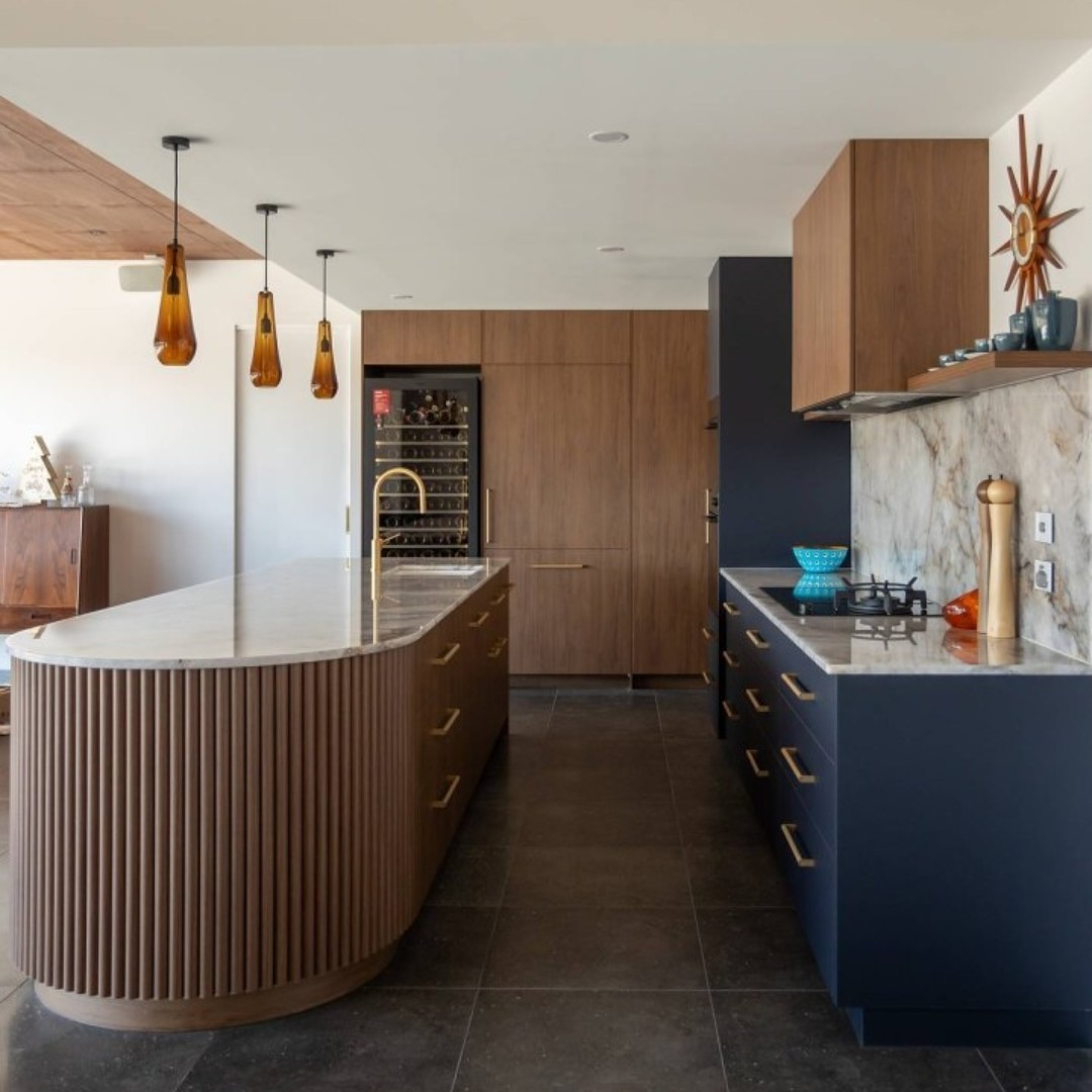 Soften Lines With a Curved Island Base Featuring Vertical Wood Slats