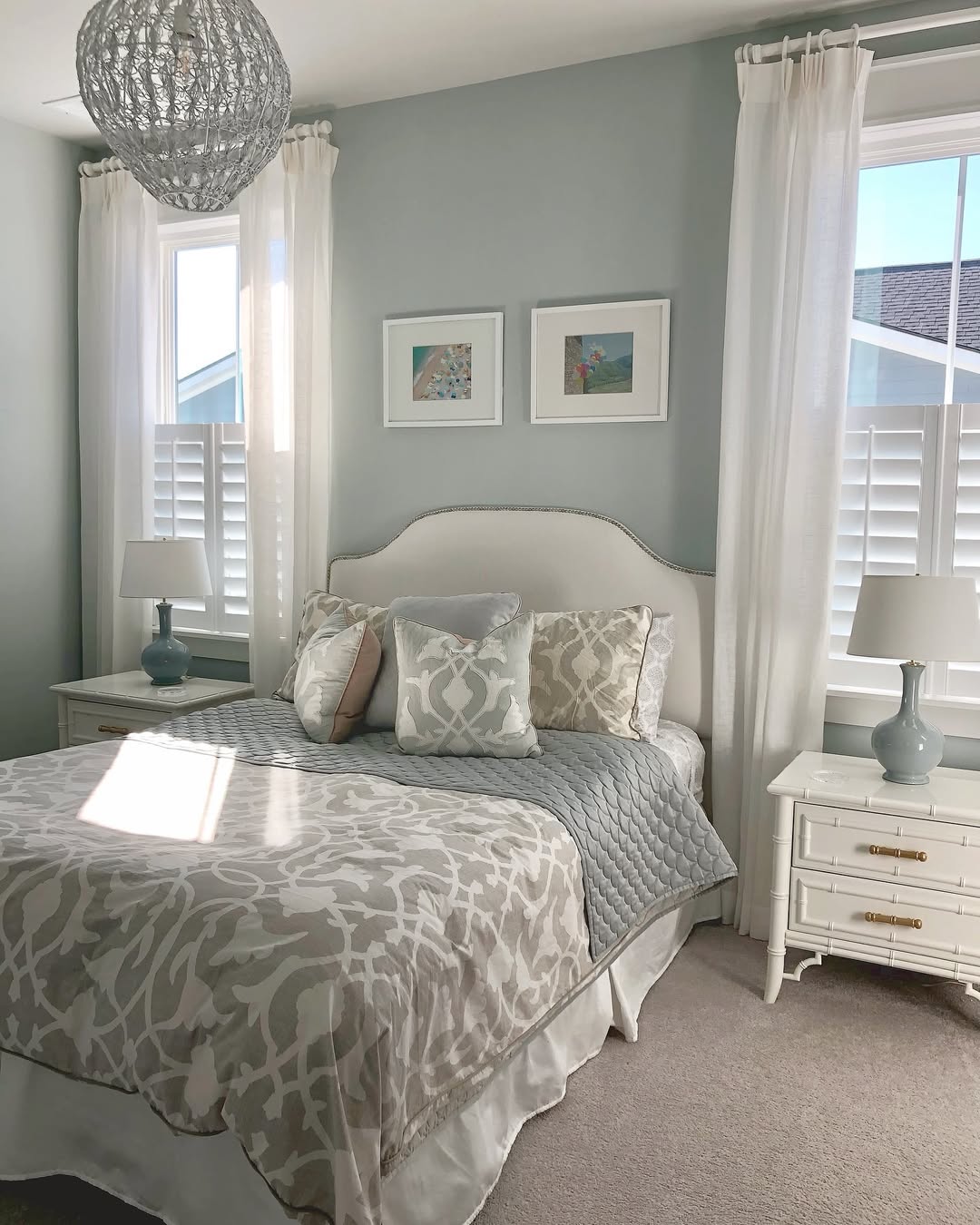 Framed Beach Scenes Add Coastal Charm Above the Bed