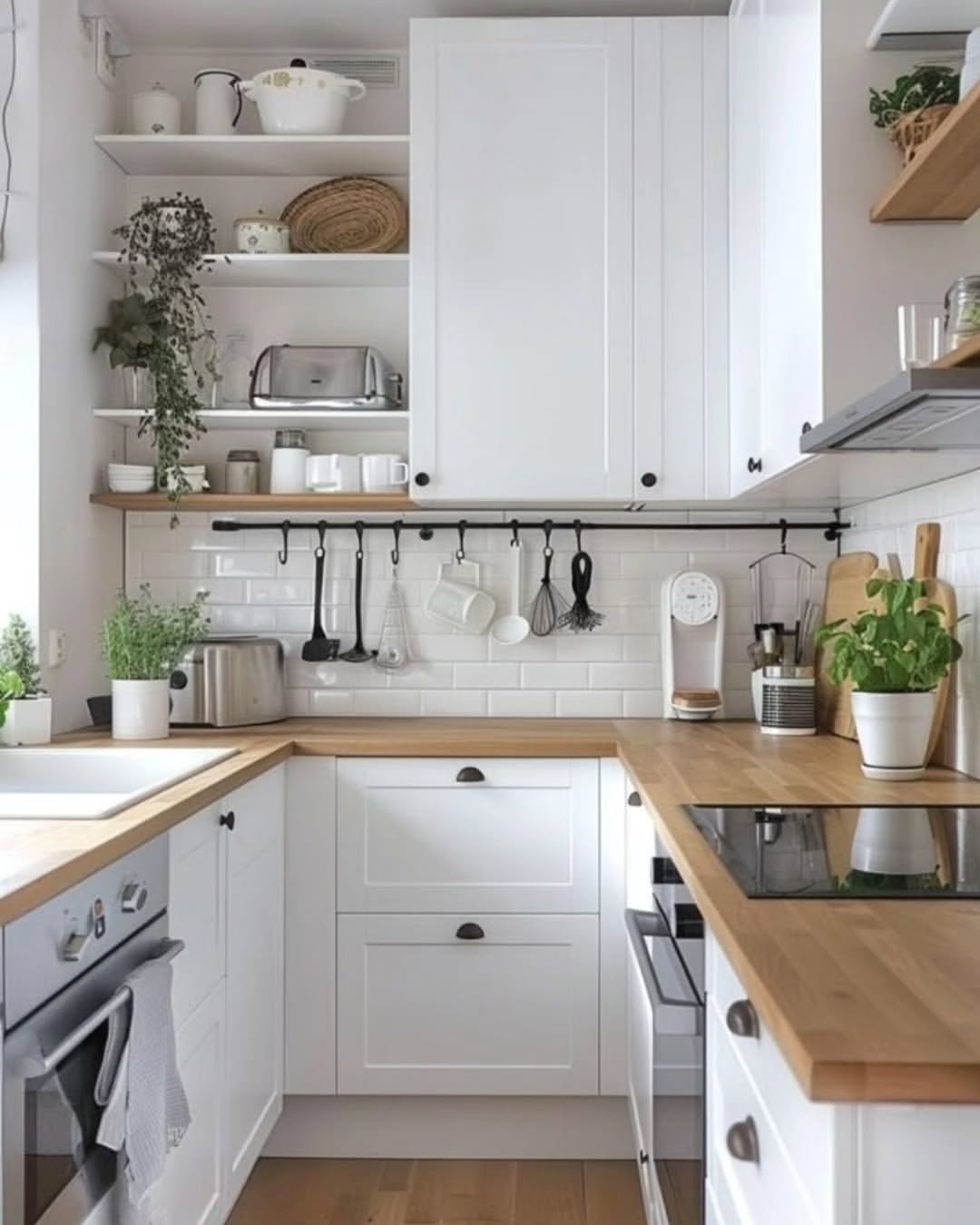 Open Shelving with Greenery Softens White Cabinets