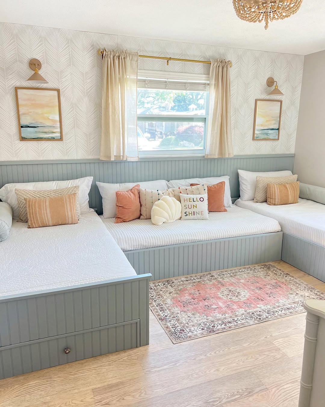 Coastal Artwork Above Built-In Beds Adds Serene Ambiance