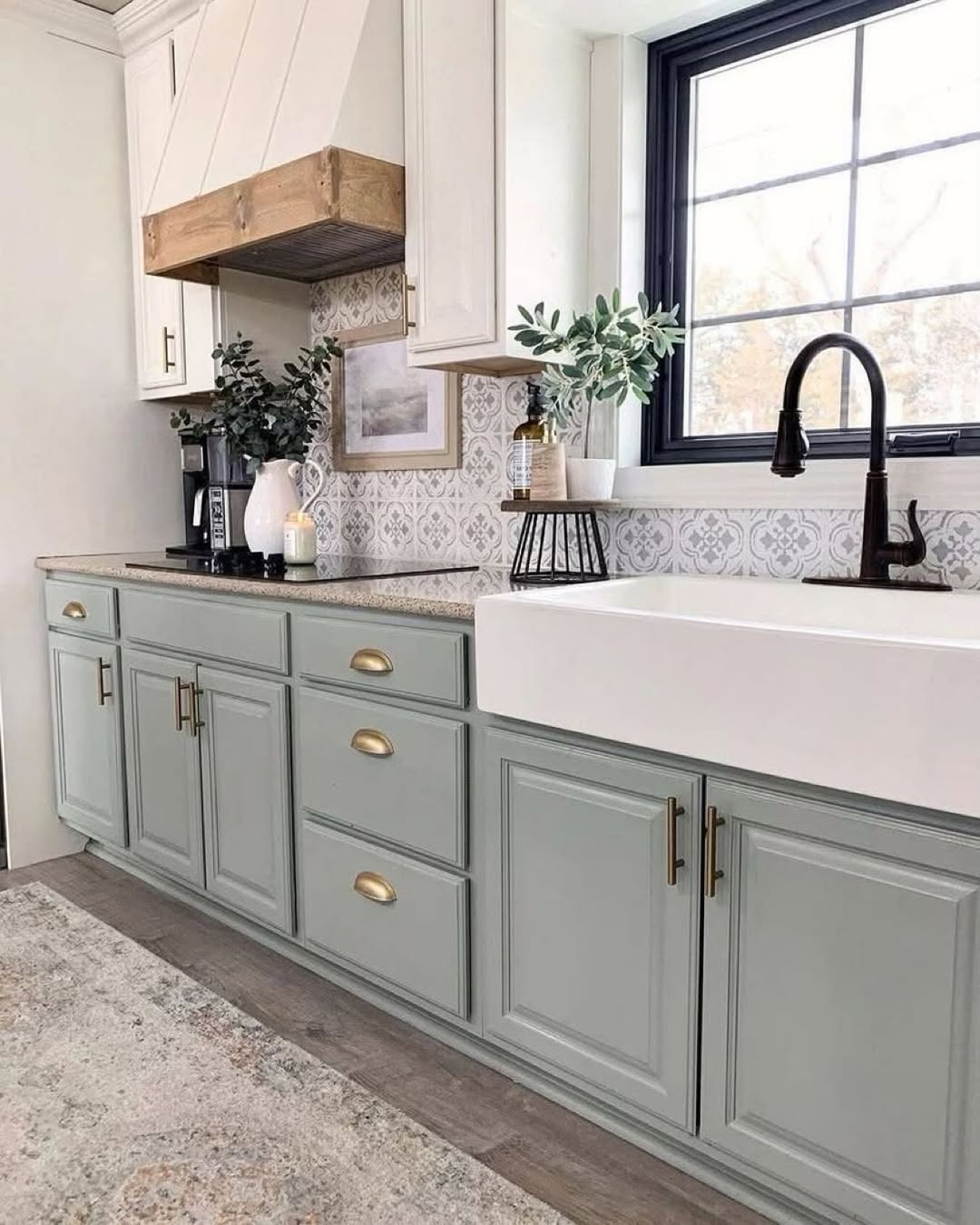 Gray-Green Cabinets With Brass Pulls Add Subtle Color