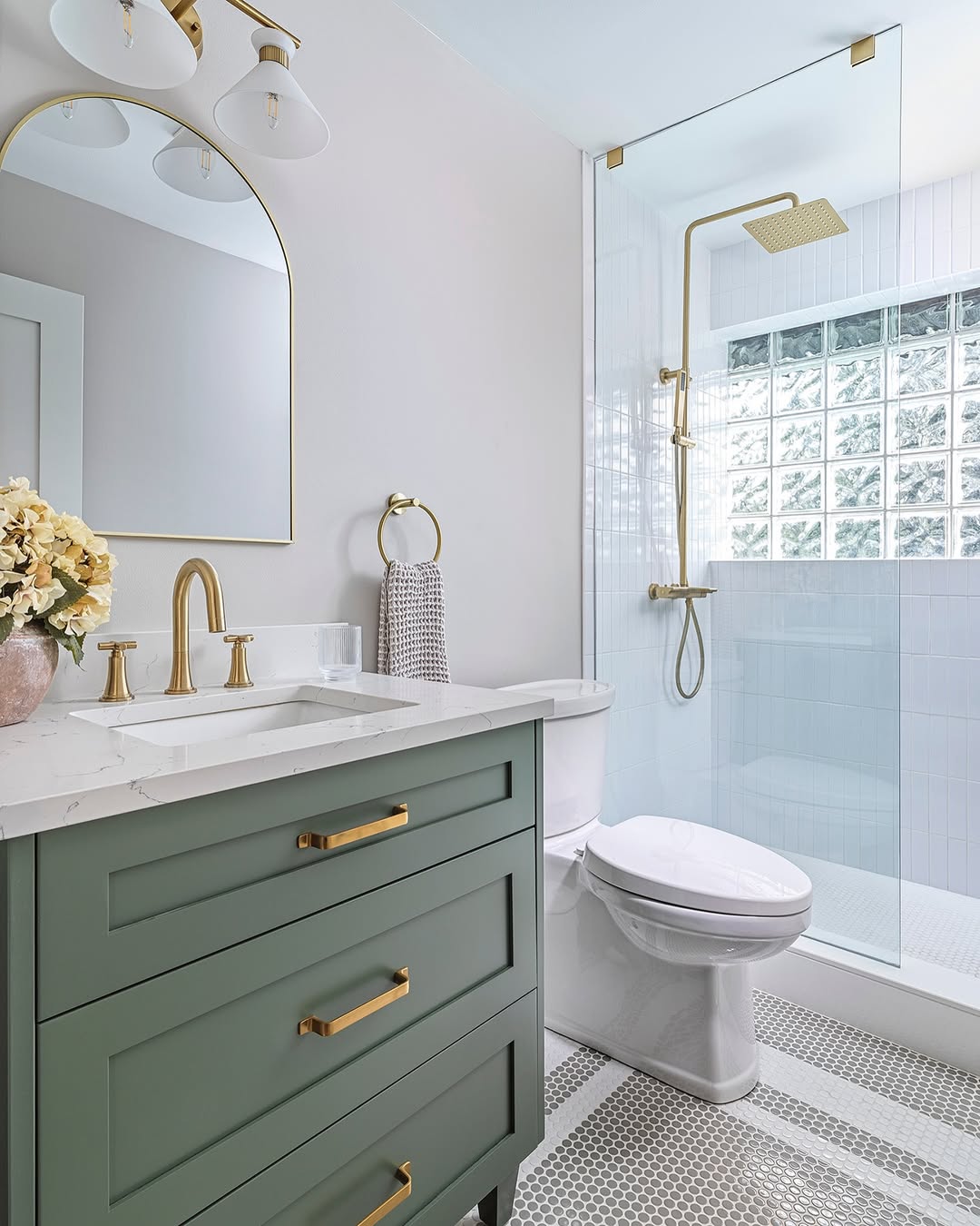 Arched Mirror with Brass Frame Warms a Green Vanity