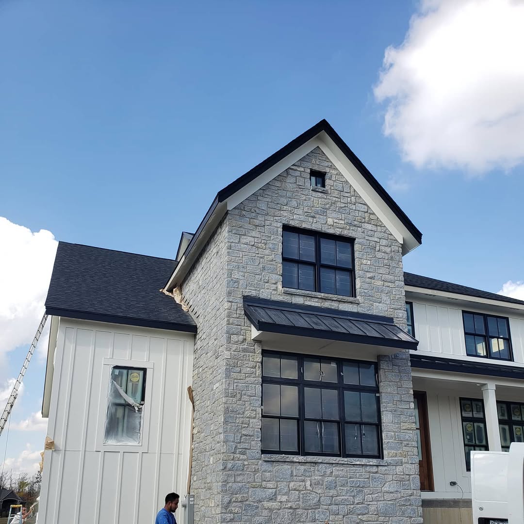 Stone Facade Paired with Black Metal Awnings