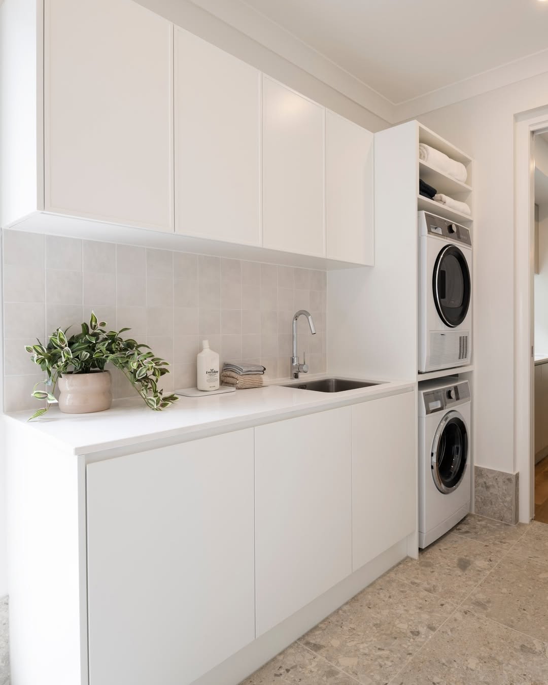 White Cabinets and Countertop Create a Clean Laundry Space