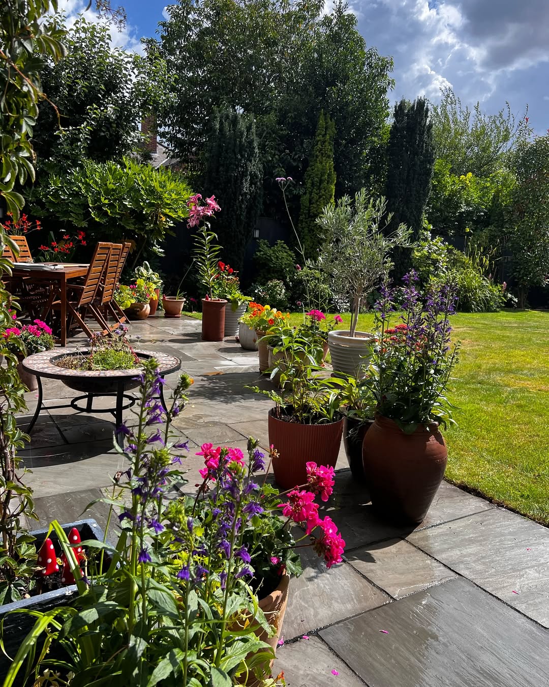 Grouped Terracotta Pots Add Warmth to Paved Patio