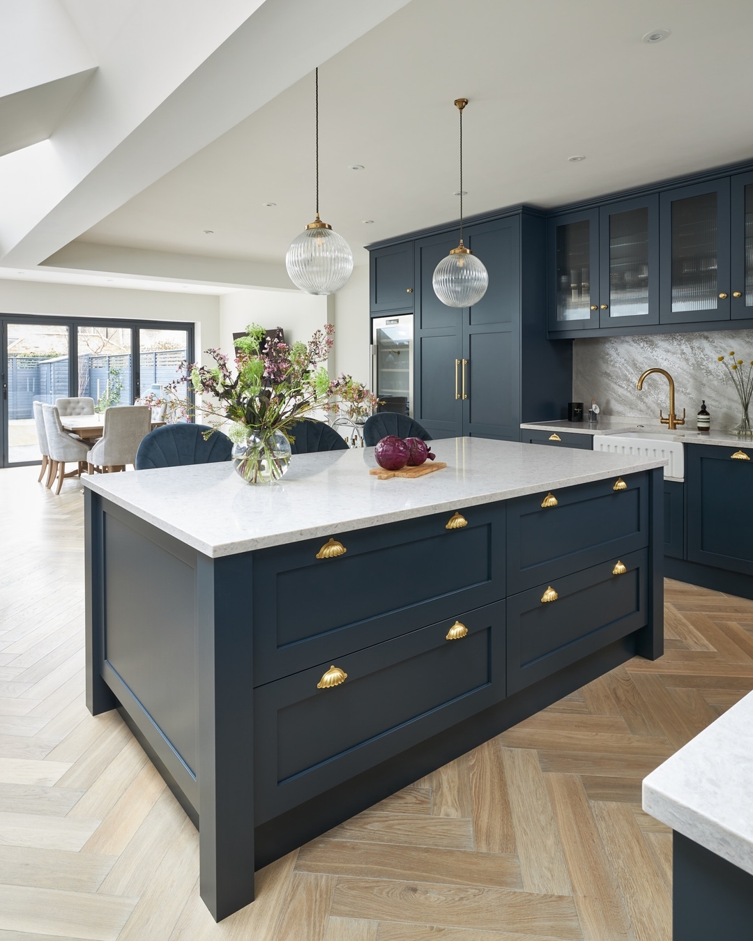 Fluted Globe Pendants Add Airy Texture Above Island