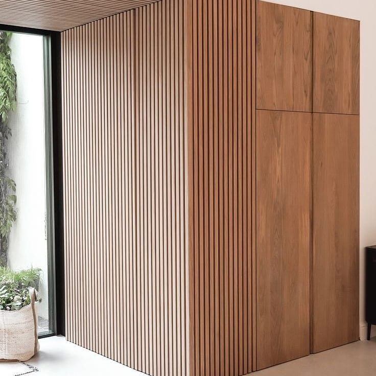 Wood Slat Wall Panels Conceal Built-In Cabinetry