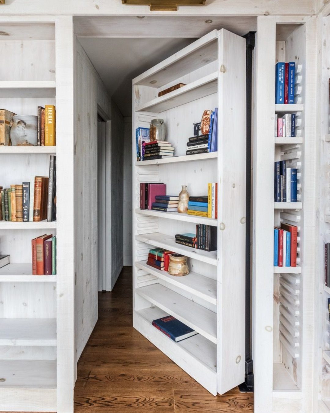 Tall White Bookshelf Door Swings Open to Reveal a Hallway