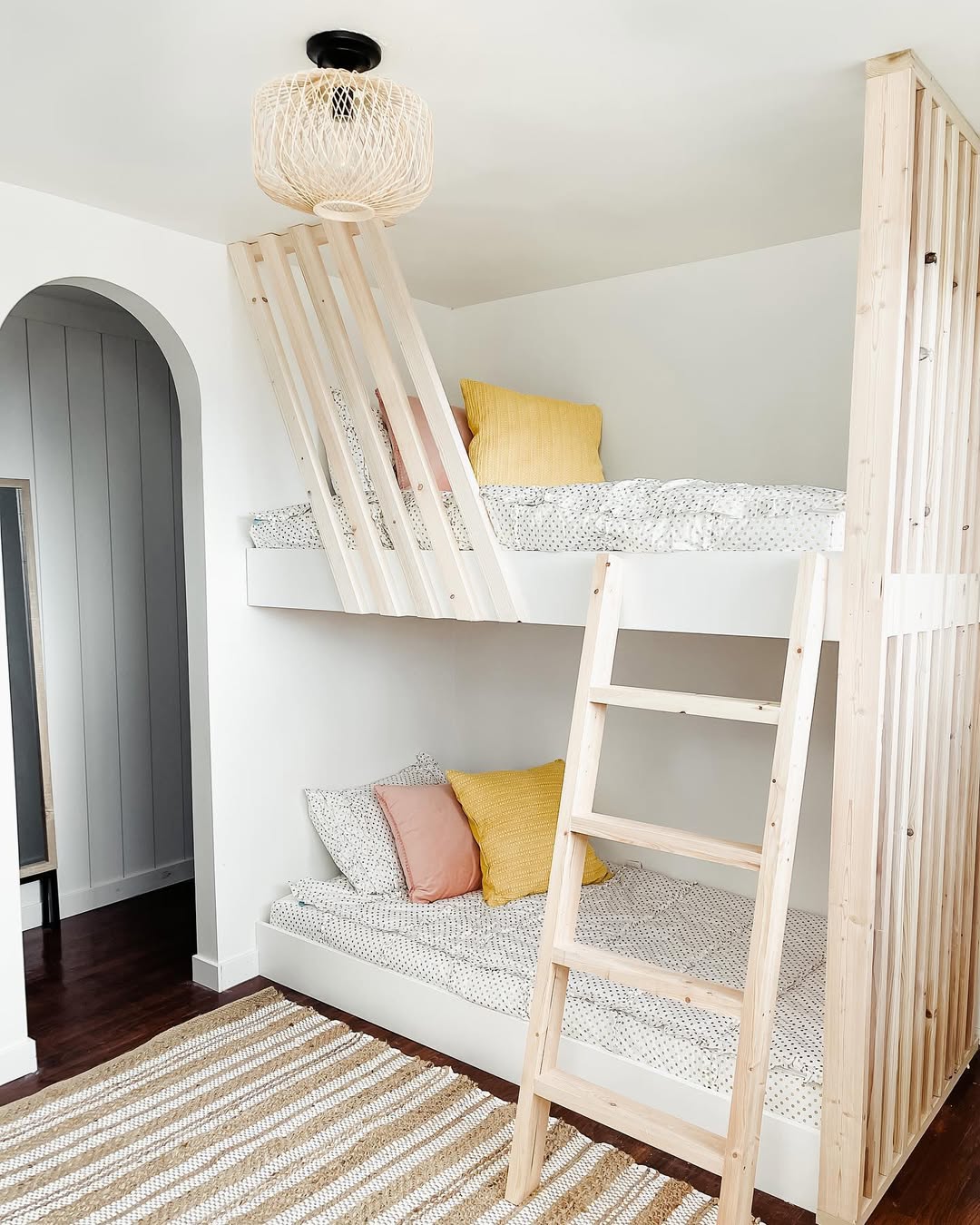 Slatted Wood Partition Creates Cozy Nooks Within Bunk Beds
