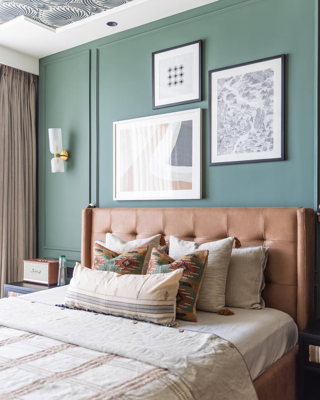 Layered Artwork Adds Depth Above a Tufted Headboard