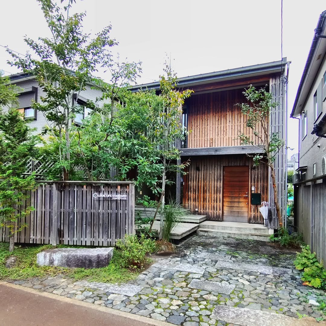 Wooden Fencing With Integrated Signage Creates a Welcoming Entry