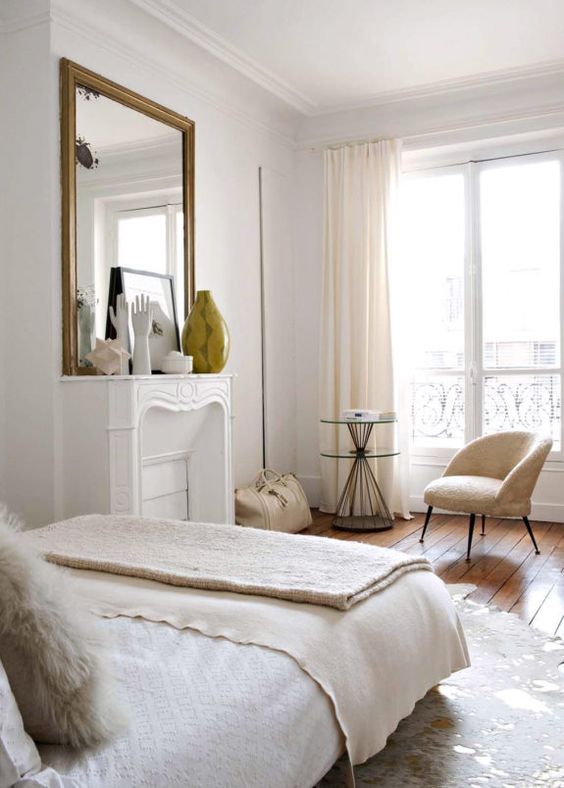 Reflect Sculptural Objects with a Gold Mirror Above the Mantel
