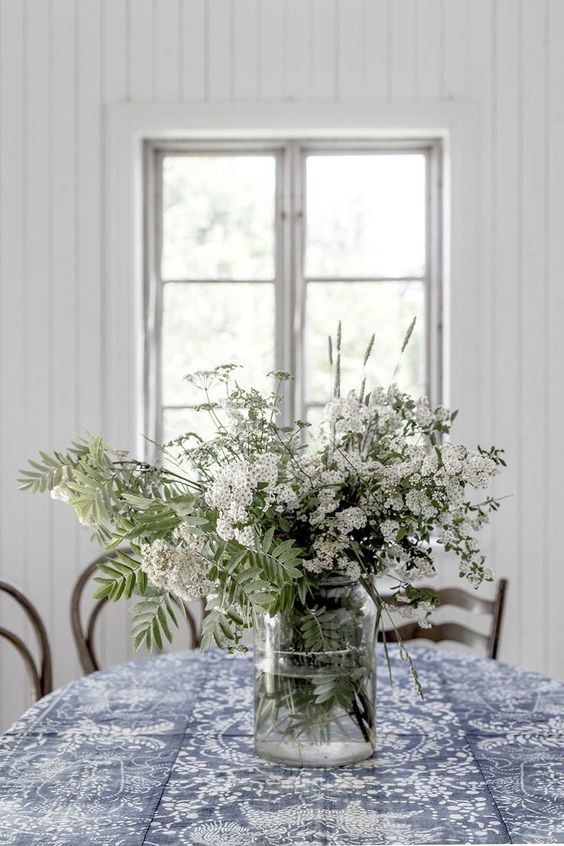 Tall Glass Jar Holds Abundant Wildflower Arrangement