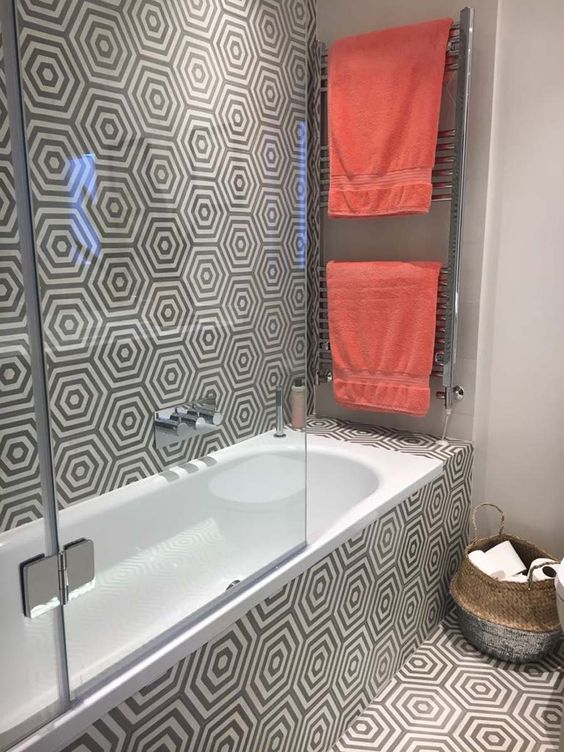 Geometric Grey and White Tiles Unify Bathroom Walls and Floor