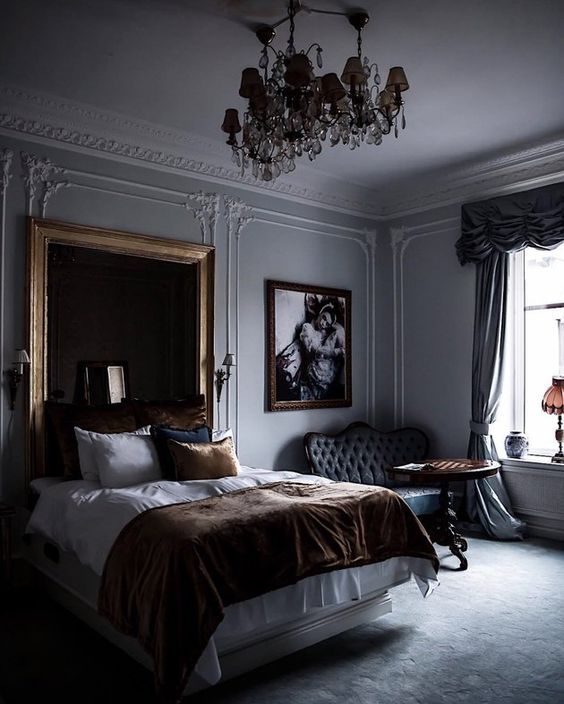 Gold Mirror Frames a Tall Headboard and Artwork