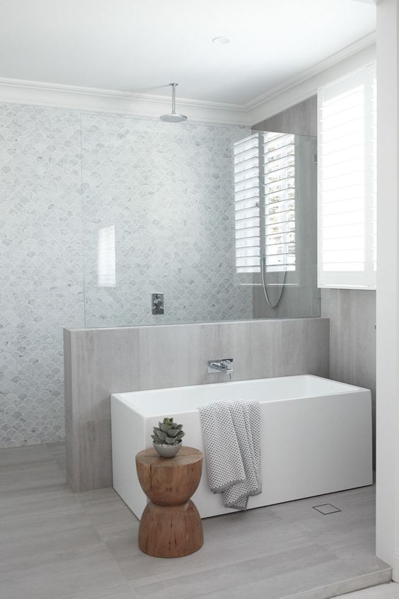 Place a Wooden Stool Next to a White Tub for Natural Contrast