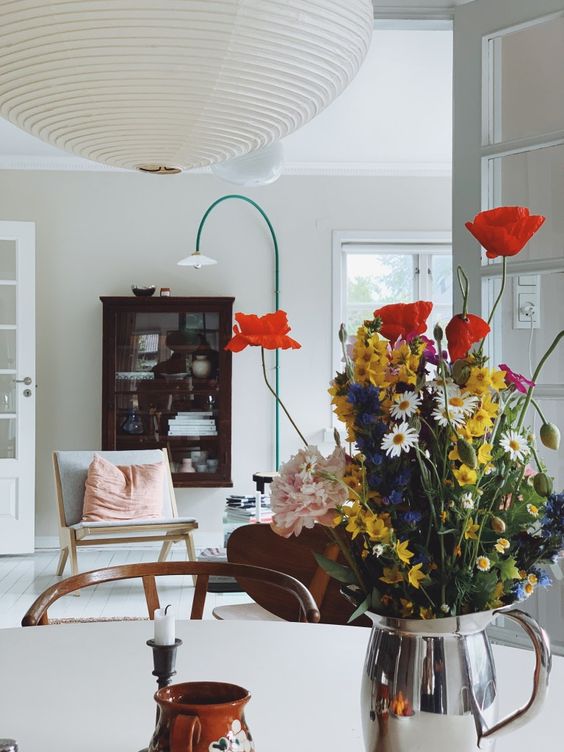 Silver Pitcher Holds a Wildflower Bouquet with Poppies