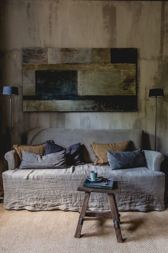 Patchwork Art Adds Moody Texture Above a Neutral Sofa