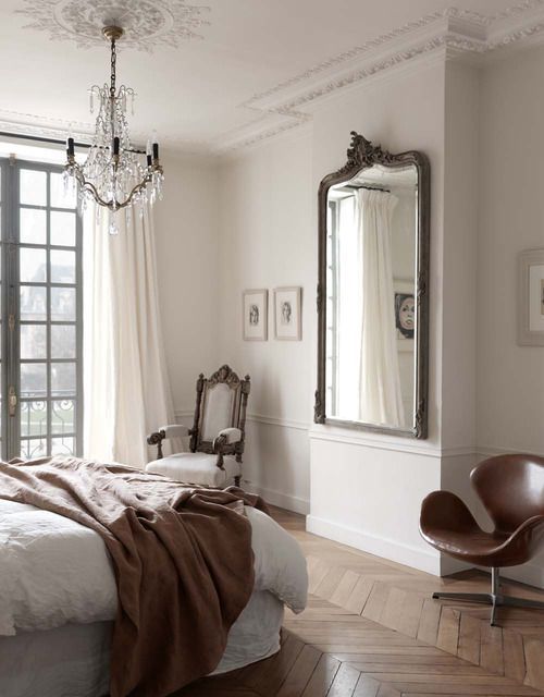 Ornate Mirror Anchors Wall With Subtle Artwork Placement