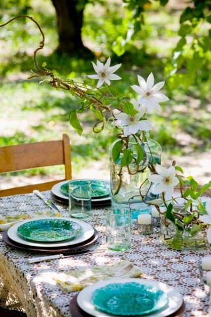 Tall Vase Holds Flowing Clematis Branches