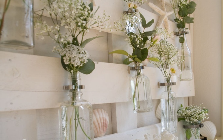 Glass Bottles Hung on Wood for Delicate Single-Stem Displays