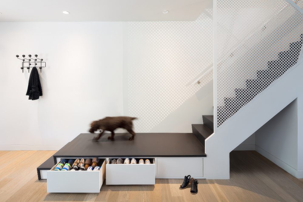 White Drawers Underneath a Raised Platform for Shoe Storage