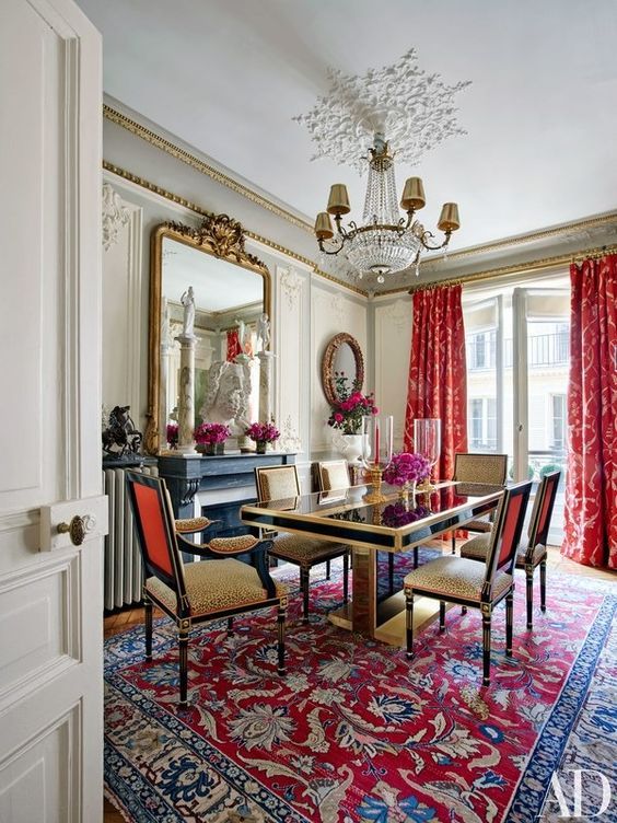 Ornate Red and Blue Rug Anchors a Formal Dining Space