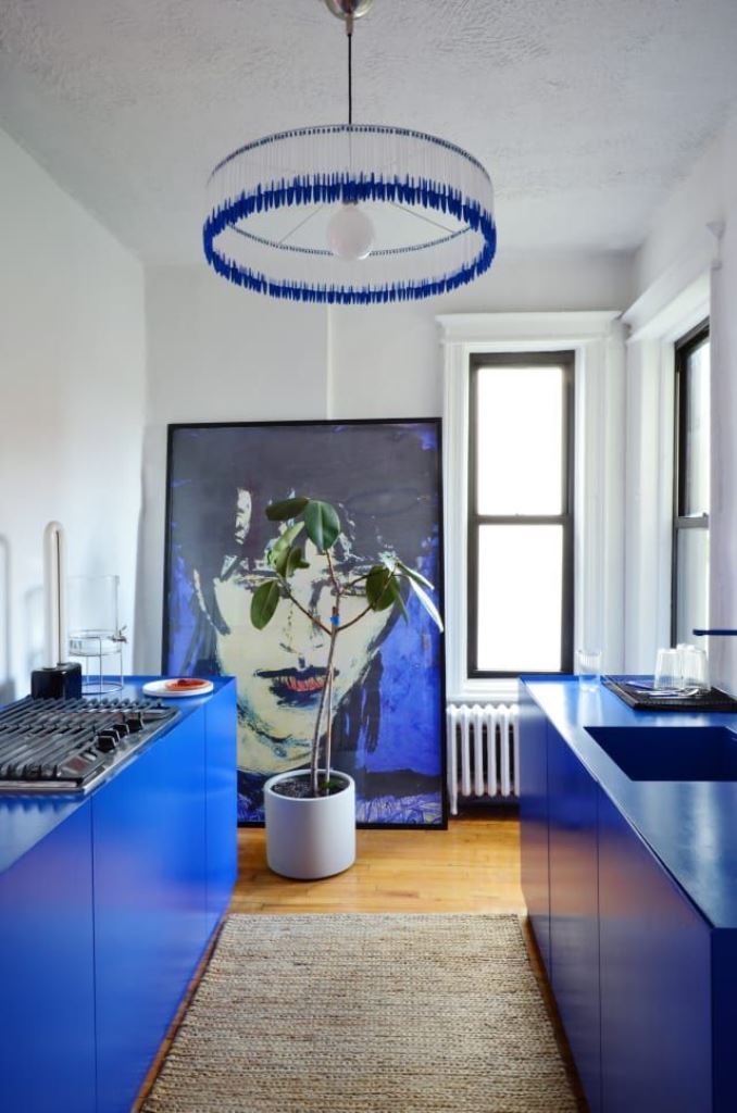 Oversized Blue Art Anchors a Bold Blue Kitchen