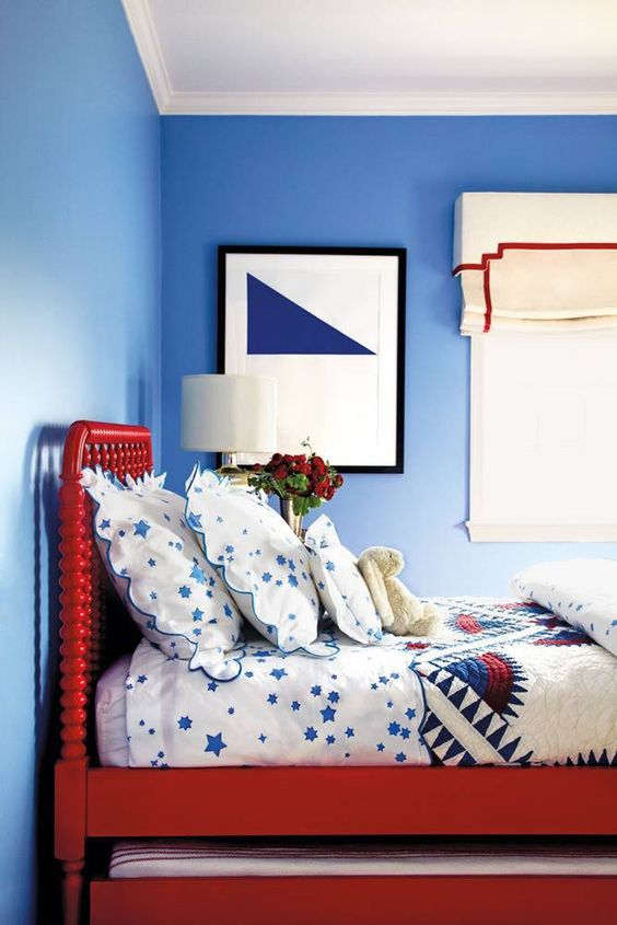 Red Spindle Bed Frame With Star-Patterned Bedding