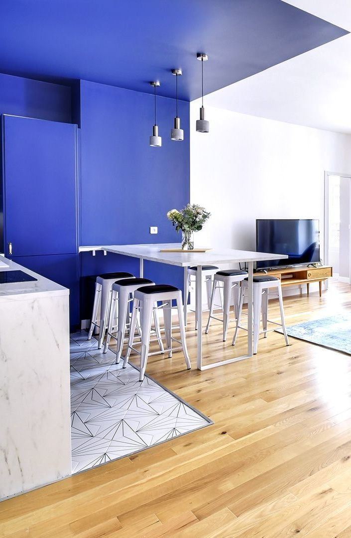 Geometric Tile Inlay Defines Kitchen and Dining Zones