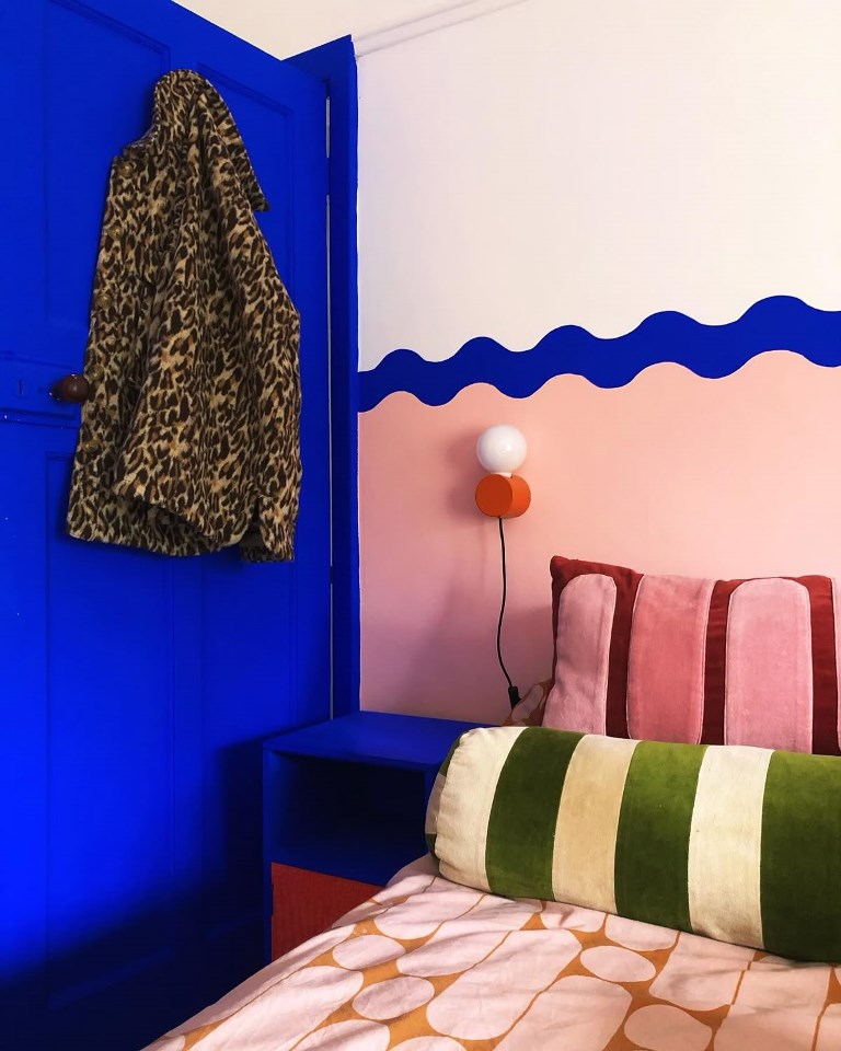Wavy Blue Wall Mural Adds a Playful Border Above Bed